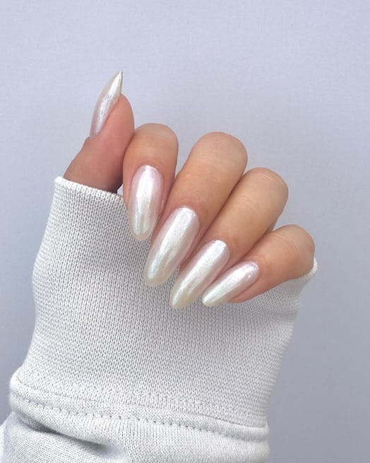 Neutral chrome nails are on-trend for winter 2024. Here, a white chrome manicure.
