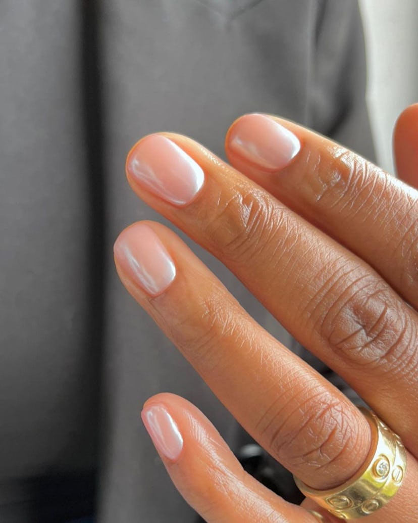 Neutral chrome nails are on-trend for winter 2024. Here, a nude chrome manicure.