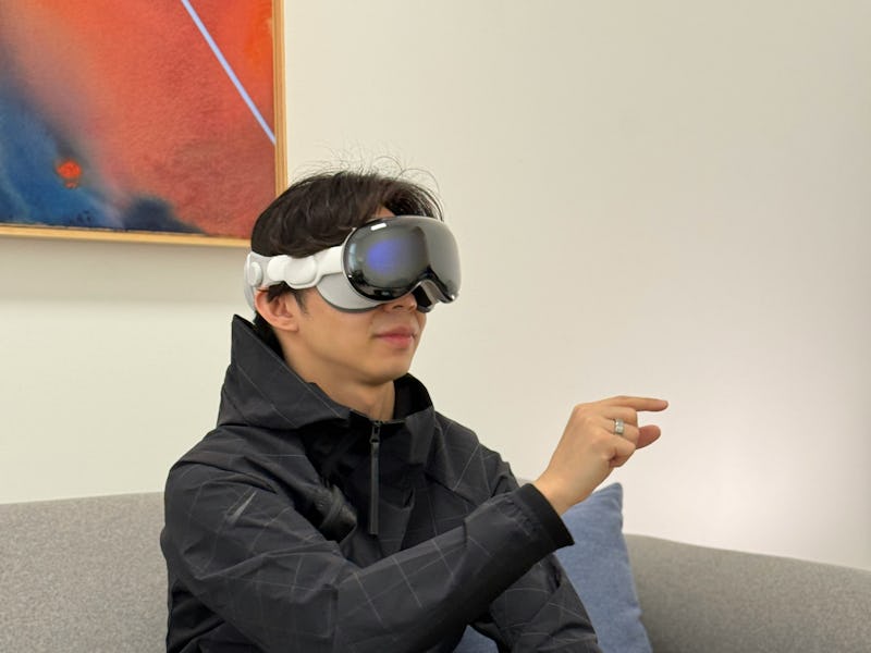 Inverse Deputy Editor Ray Wong wearing Apple Vision Pro and using hand tracking to control visionOS