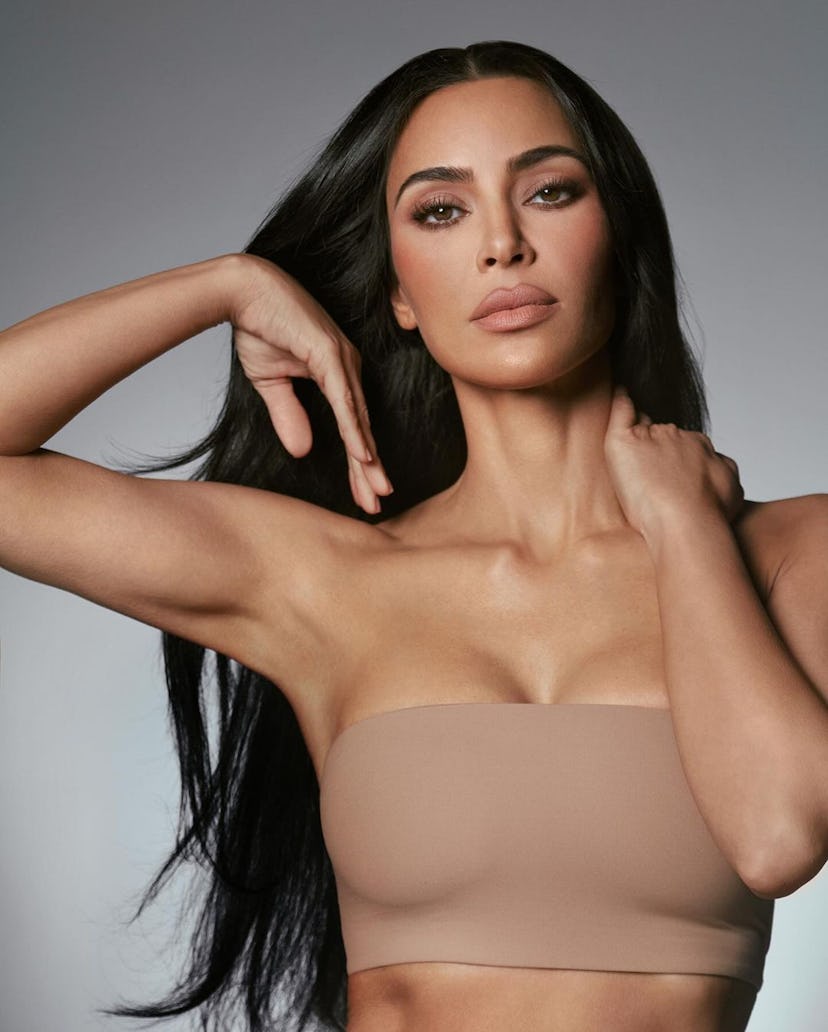 Kim Kardashian wears a beige bandeau.