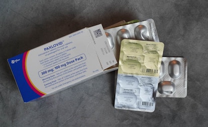 Paxlovid pill pack on table, in a story answering the question, can you take paxlovid while pregnant...