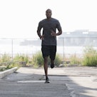 A man doing a fartlek run outdoors.