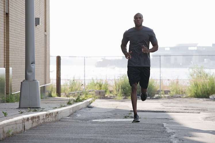 A man doing a fartlek run outdoors.