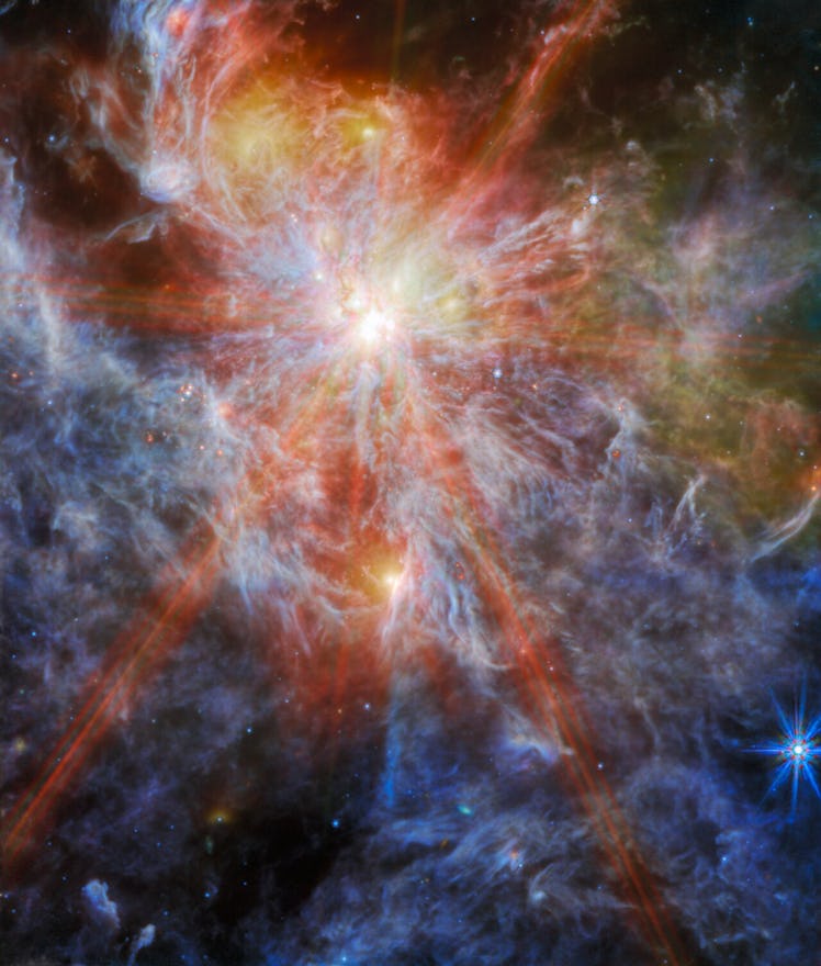 A bright young star within a colourful nebula. The star is identifiable as the brightest spot in the...