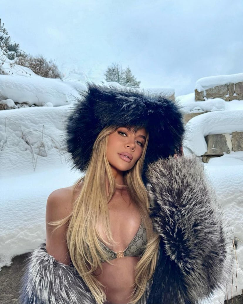 Khloé Kardashian wears a faux fur coat and a Gucci bikini.