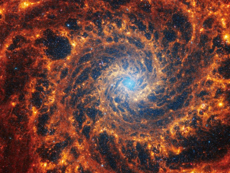 Webb’s image of NGC 628 shows a densely populated face-on spiral galaxy anchored by a central region...