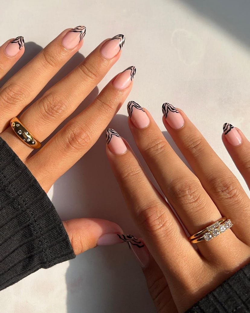 Zebra print French tip nails are on-trend for 2024.