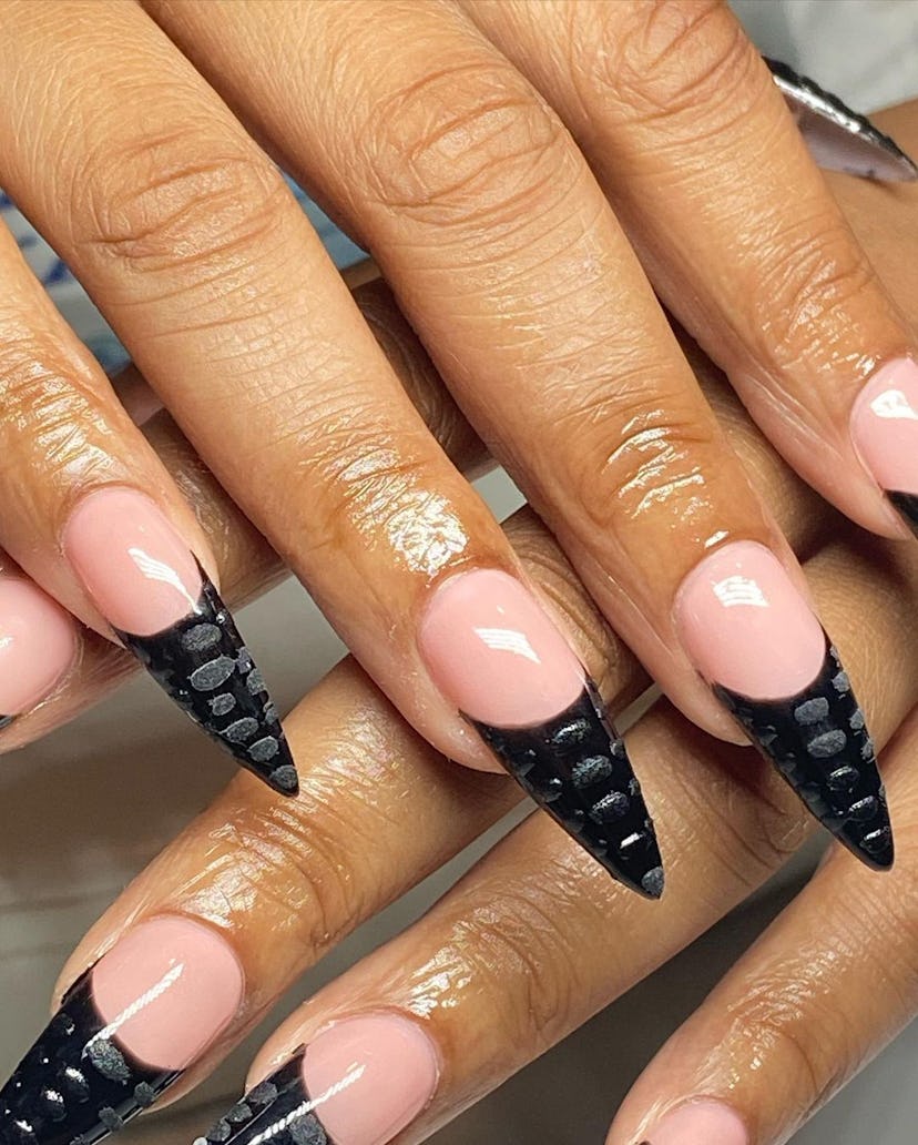 Black French tip nails with a textured croc print are on-trend for 2024.