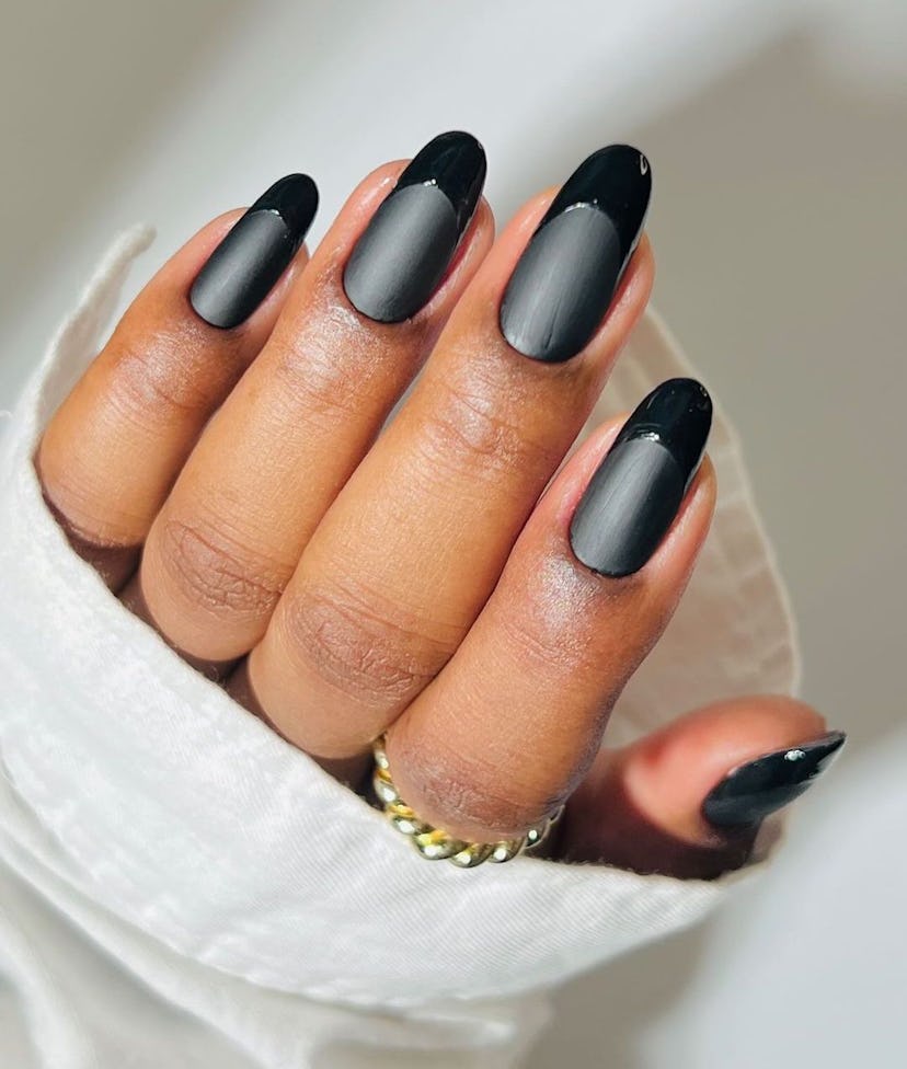 Monochromatic black French tip nails are on-trend for 2024.