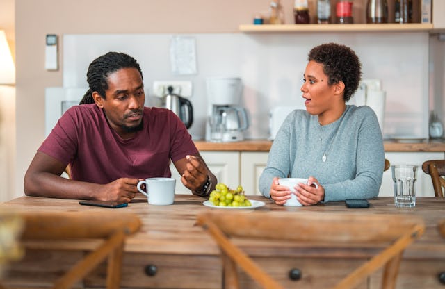 A couple talks over a meal.