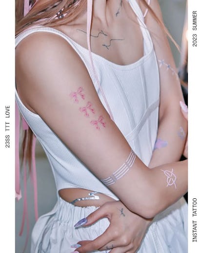 13 Adorable Coquette Tattoo Ideas Inspired by Hailey Bieber's Dainty Bow 37 Three small bow tattoos.