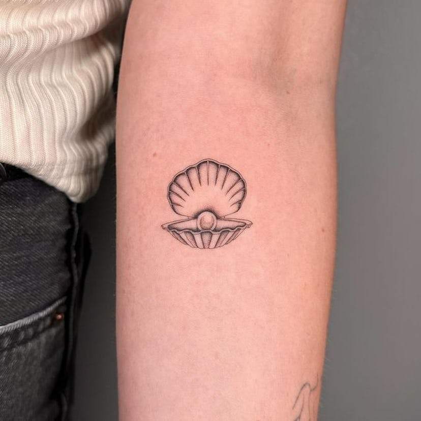 Clam shell pearl tattoo.