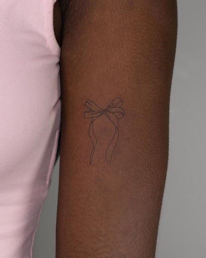 13 Adorable Coquette Tattoo Ideas Inspired by Hailey Bieber's Dainty Bow 29 Simple ribbon tattoo.