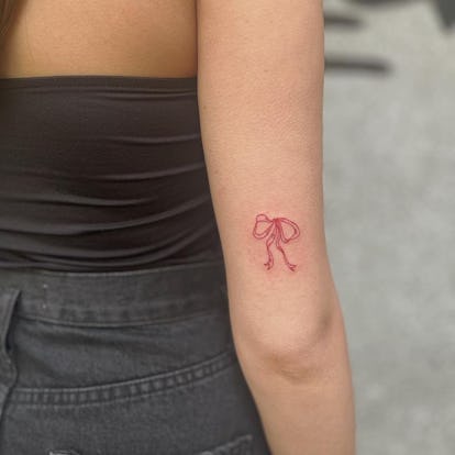 13 Adorable Coquette Tattoo Ideas Inspired by Hailey Bieber's Dainty Bow 33 Red ribbon tattoo.