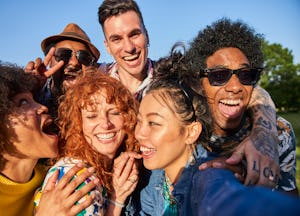 A group of young friends smiling and laughing not knowing which one of them is most likely to be a f...