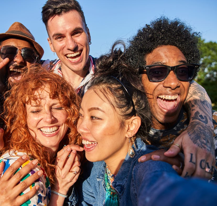 A group of young friends smiling and laughing not knowing which one of them is most likely to be a f...