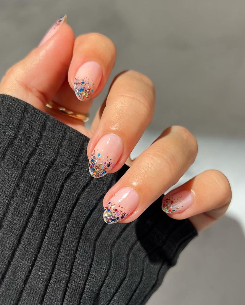 Colorful glitter French tips are a trendy French manicure idea for 2024.