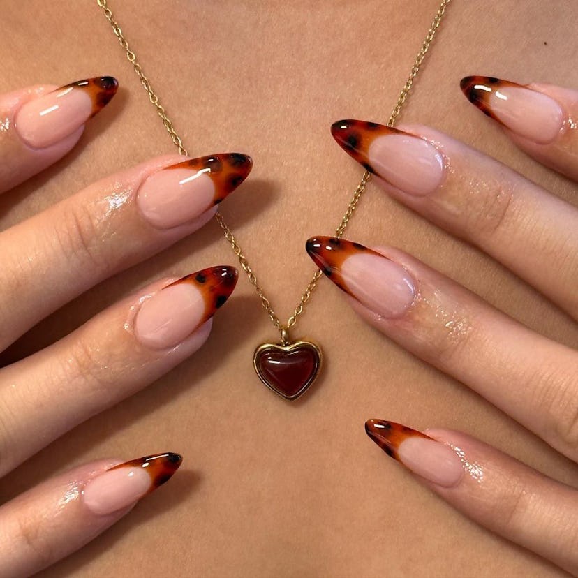 Tortoiseshell French tips are a trendy French manicure idea for 2024.