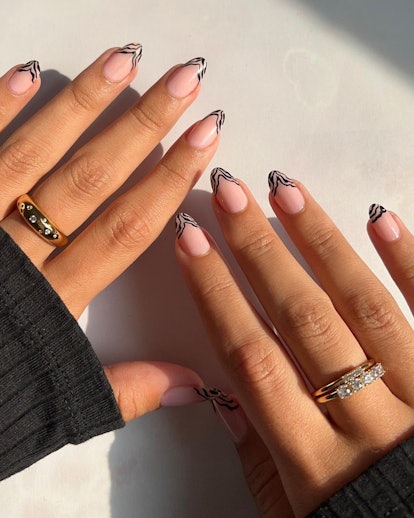 Abstract thin line French tips are a trendy French manicure idea for 2024.