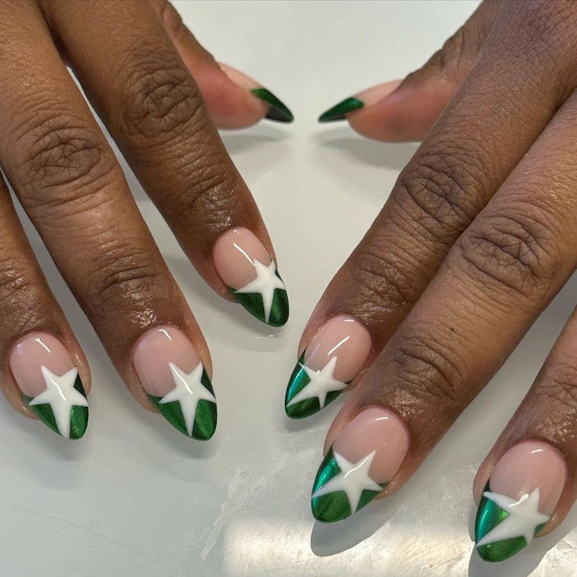 Chrome French tips with star designs are a trendy French manicure idea for 2024.