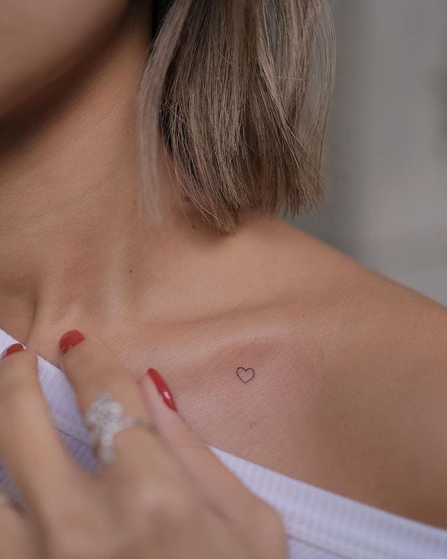 Tiny heart tattoo.