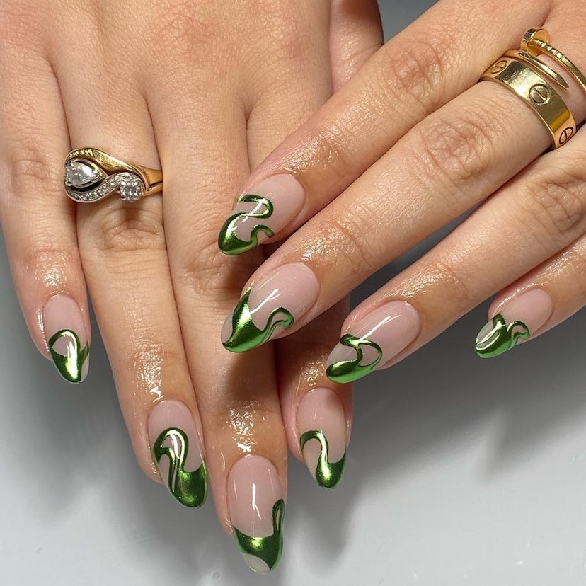Swirly green chrome French tips are a trendy French manicure idea for 2024.