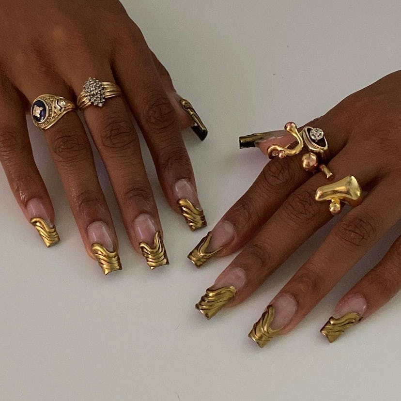 3D gold chrome French tips are a trendy French manicure idea for 2024.