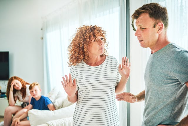 Parents have a disagreement as their kids watch.