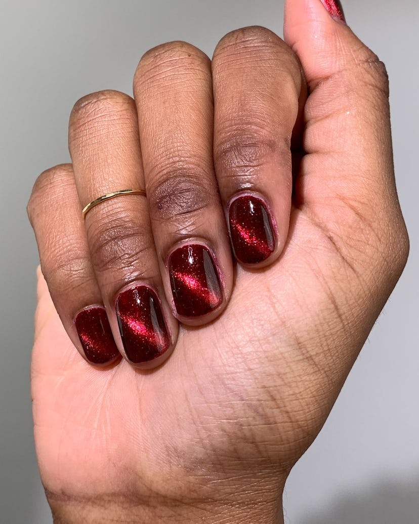 Elevate your "red nail theory" manicure with cat eye line details on each tip.