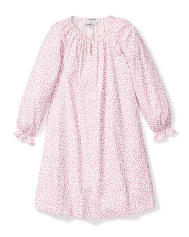 valentine's day pjs: A long-sleeve pink dress with a small floral pattern, ruffled neckline, and gat...