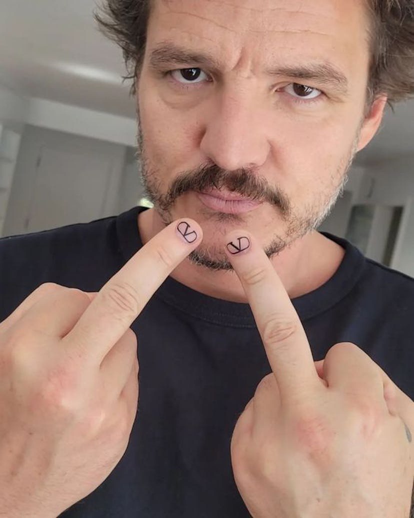 At the 2023 Met Gala, Pedro Pascal wore Valentino logo nail art on his middle fingers.
