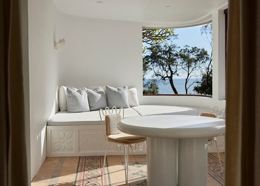 A large window seat is a feature in one of the rooms at Rae’s at Wategos, a chic seven-room property...