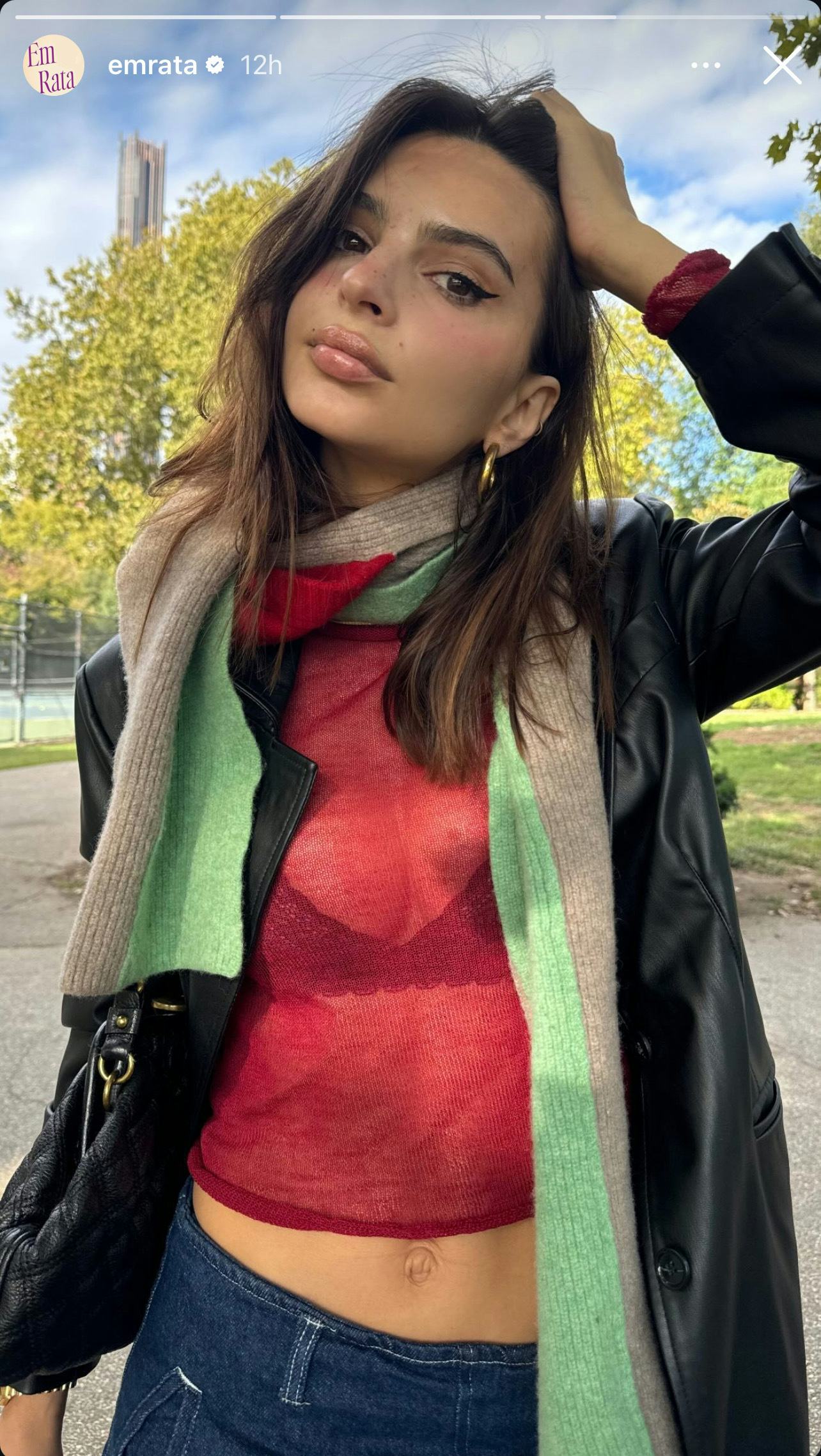 Emily Ratajkowski flaunted her bra under a red top and leather blazer.