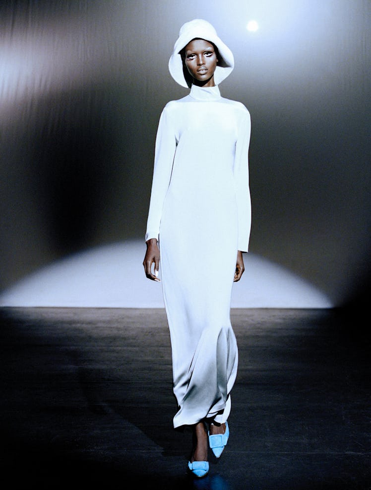 Amar Akway wears a Loro Piana dress and hat; Manolo Blahnik shoes.