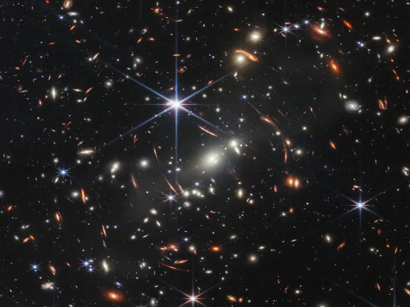 A vast, dark universe filled with countless galaxies, stars, and cosmic structures, illuminated by d...