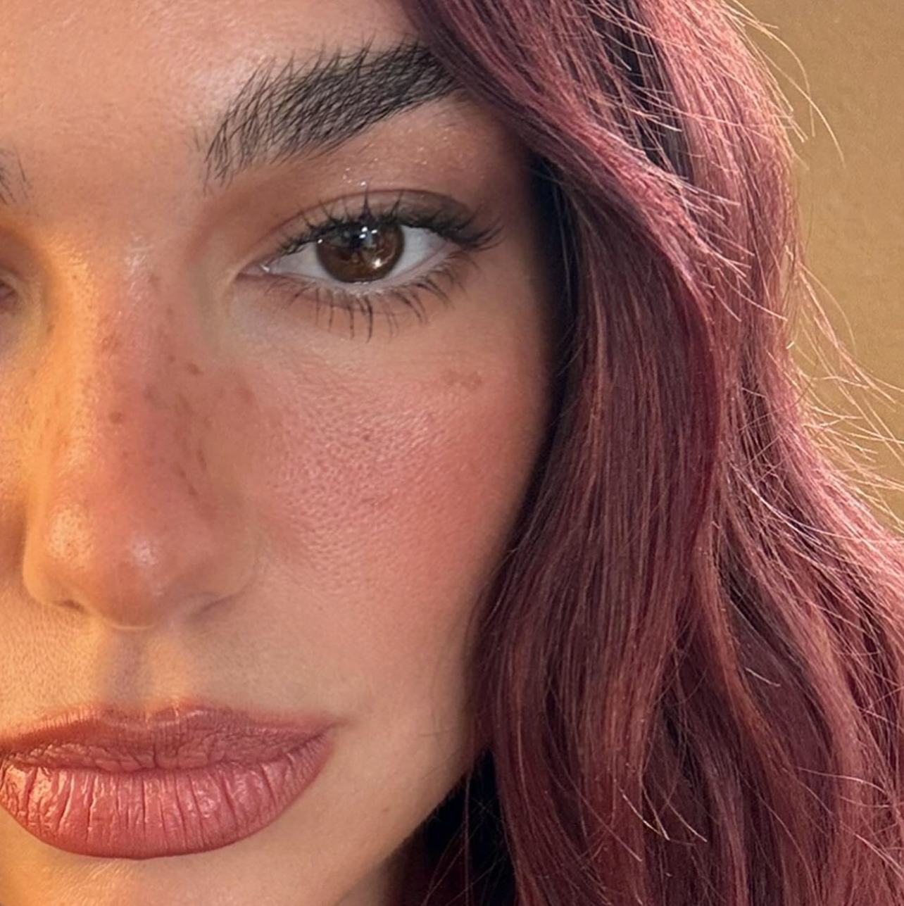 Cherry coke hair is on-trend for winter 2024.