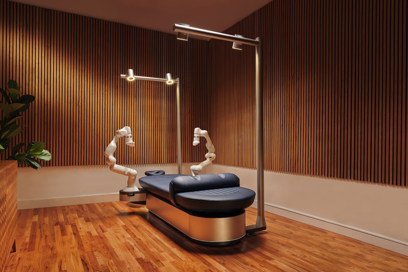 A massage with robotic arms positioned on either side