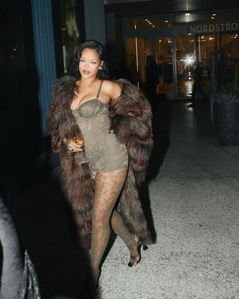 Rihanna wears a corset dress, tights, and a coat.