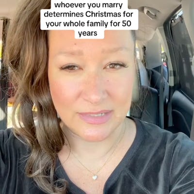 A woman with brown hair in a ponytail speaks directly to the camera from a car, sharing a thought on marriage and family Christmas traditions.