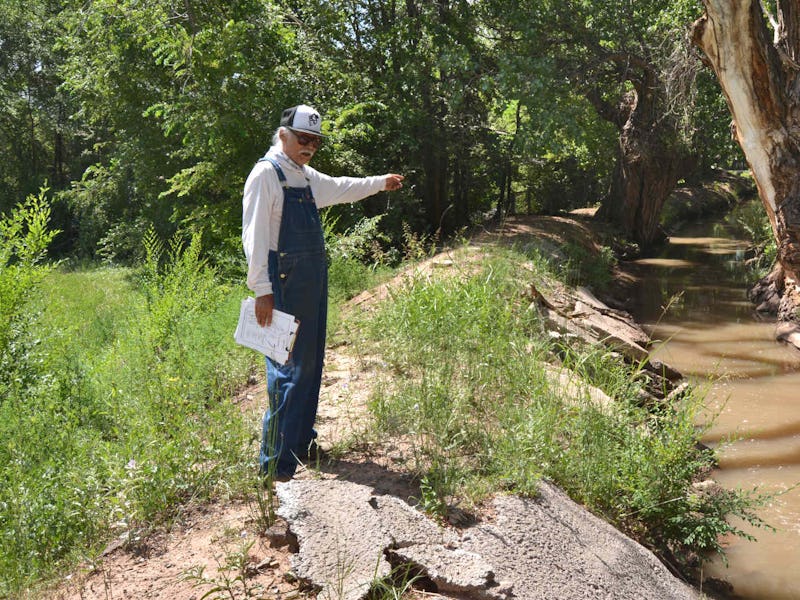 Santiago Maestas, president of the South Valley Regional Association of Acequias, stands next to the...