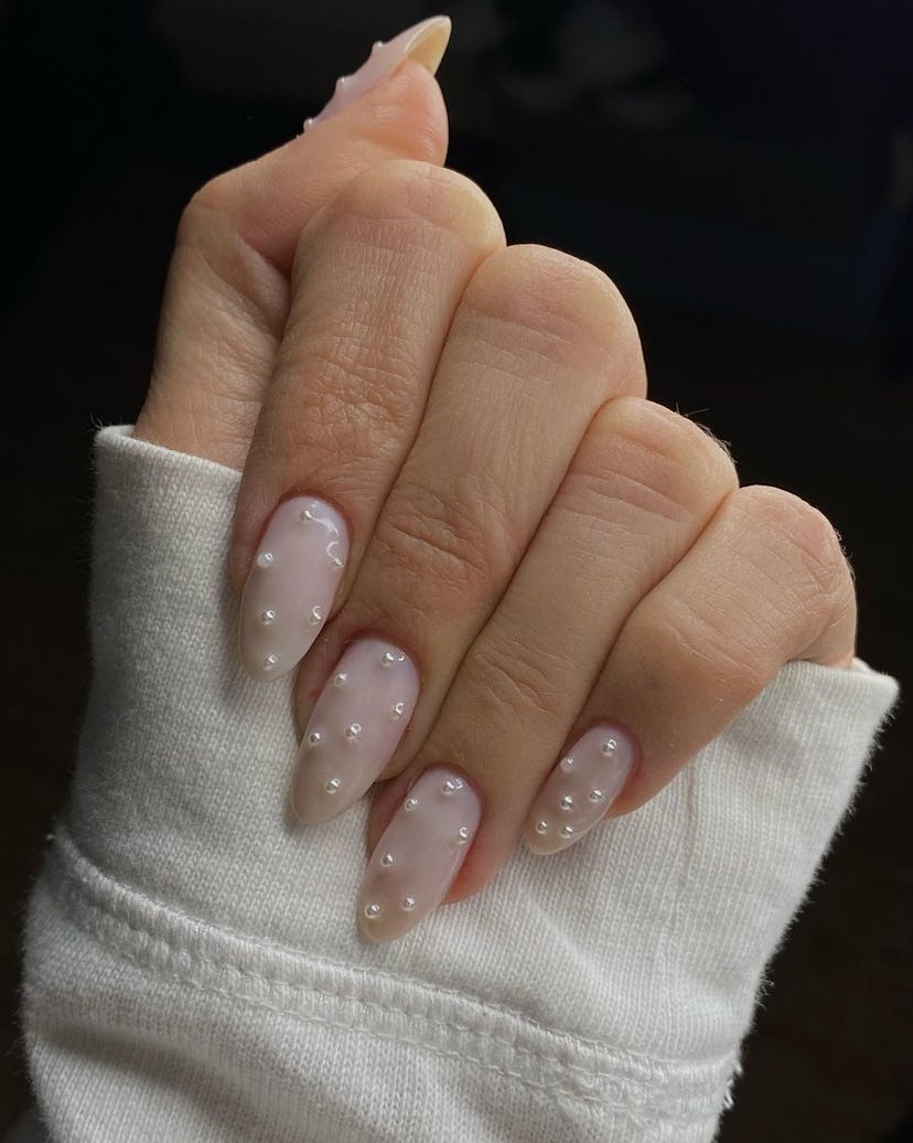 Nails with pearl accents are on-trend for winter 2025.