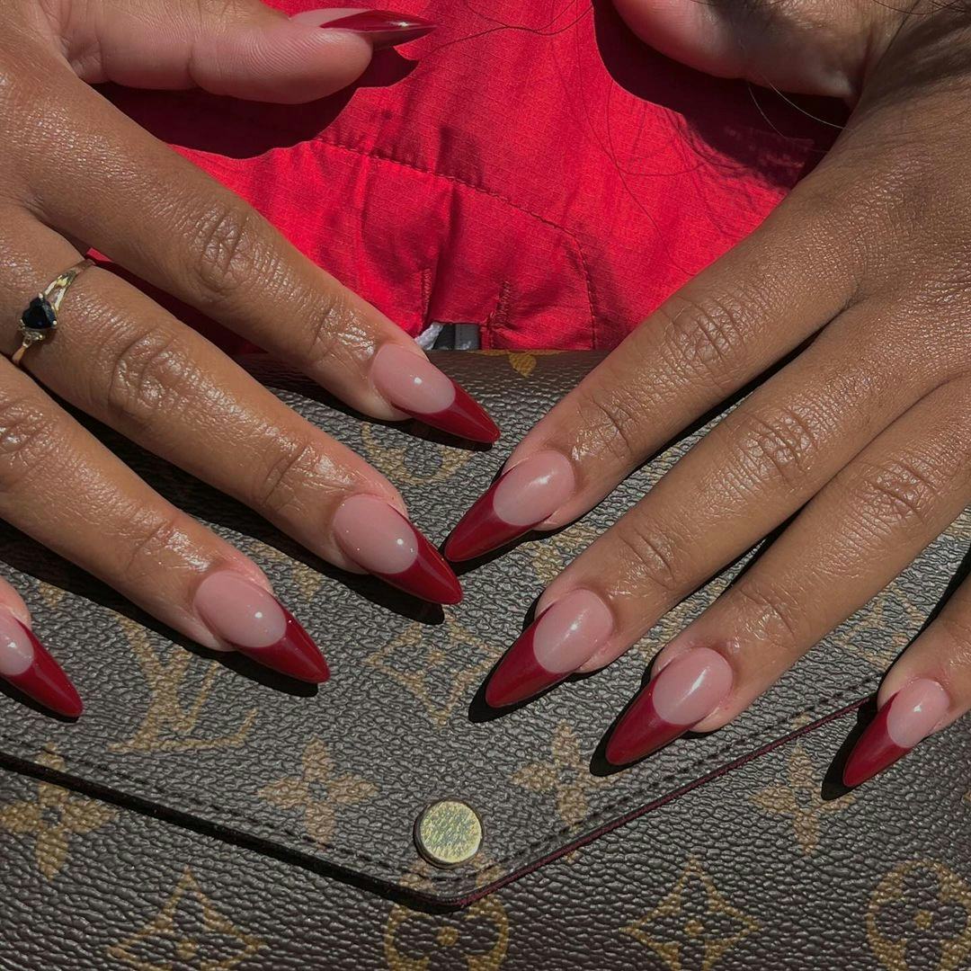 Red French tip nails are on-trend for winter 2025.
