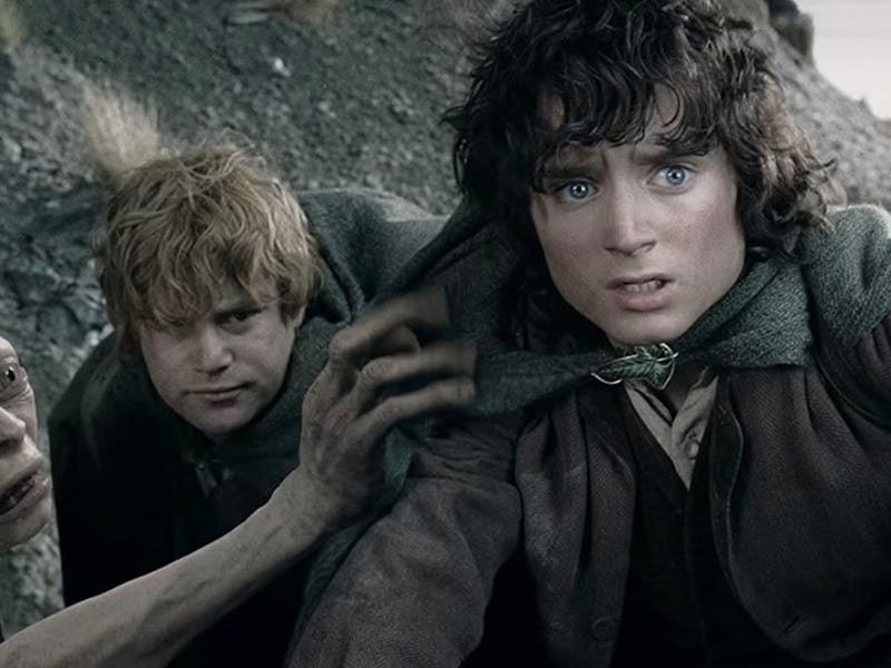 A tension-filled scene featuring three characters: a creature reaching for a young man, while anothe...