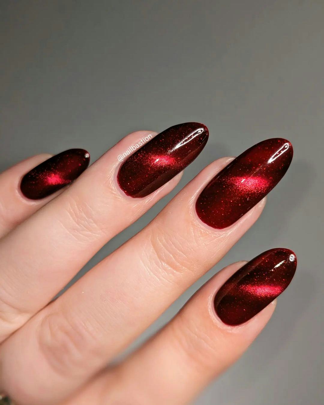 Red cat-eye nails are on-trend for winter 2025.