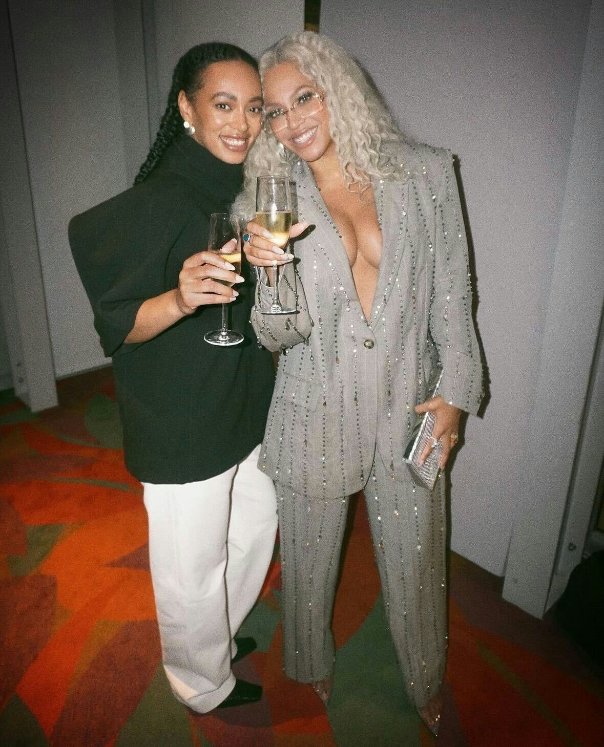Beyoncé wore a plunging gray suit with pinstripes for rare appearance with Jay-Z and Solange.