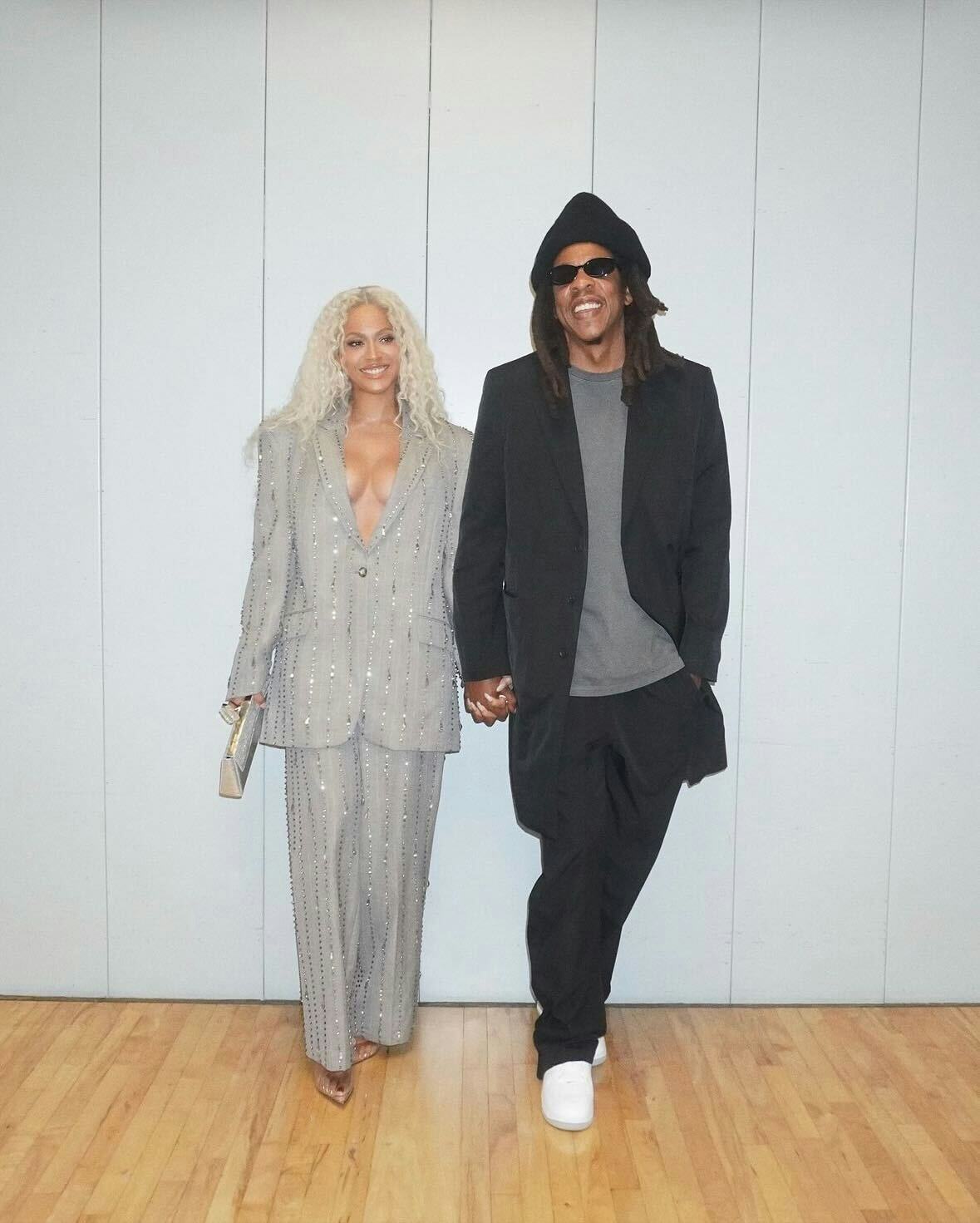 Beyoncé wore a plunging gray suit with pinstripes for rare appearance with Jay-Z and Solange.