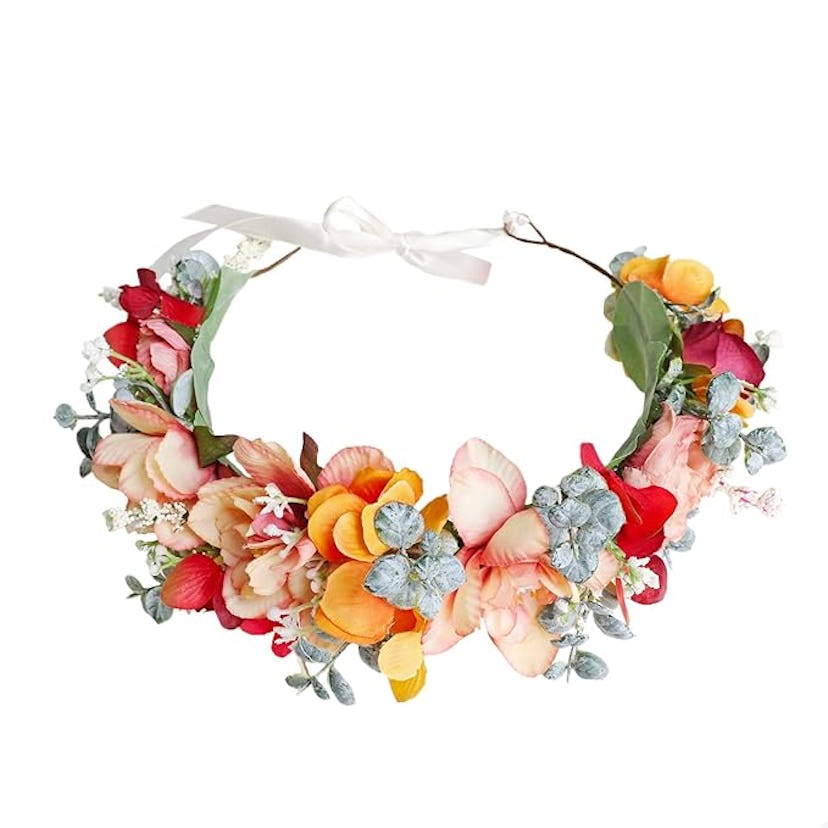 A vibrant floral crown featuring pink, orange, and blue flowers, accented with greenery and small wh...