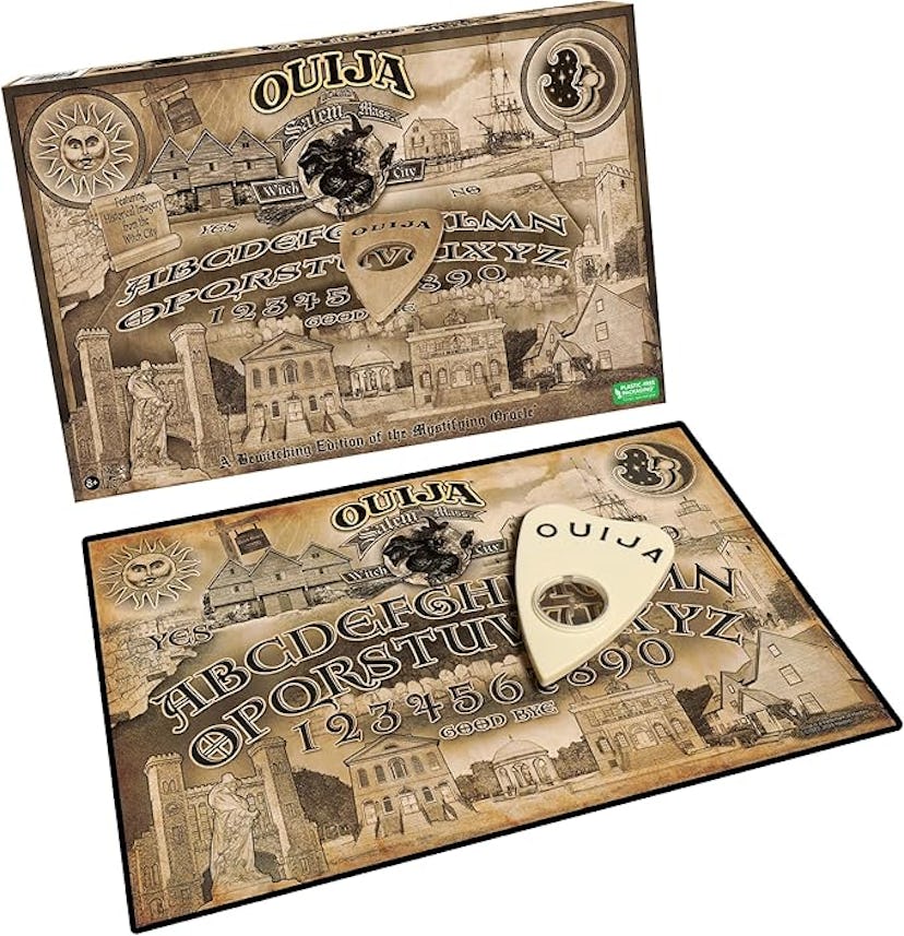 A Ouija board set featuring intricate vintage designs. The board displays letters, numbers, and symb...