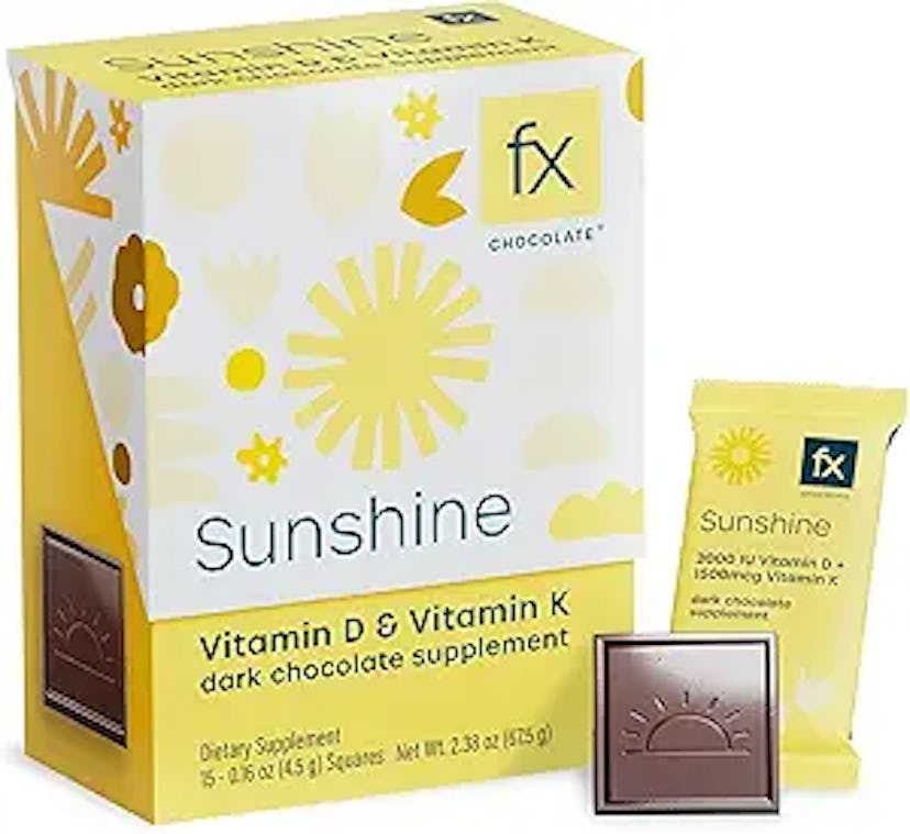 A yellow box labeled "Sunshine" containing Vitamin D & K dark chocolate supplements, alongside a sin...