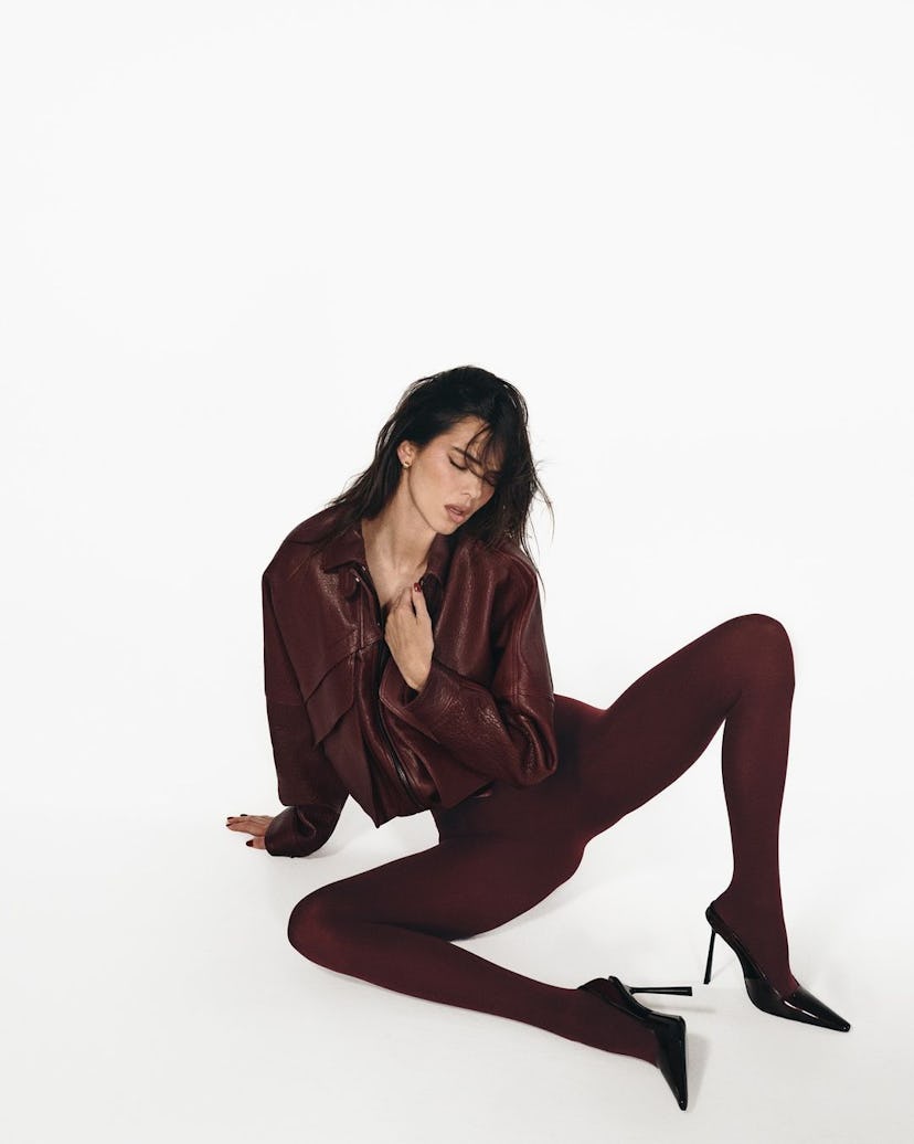 Kendall Jenner wears a thong bodysuit and tights.